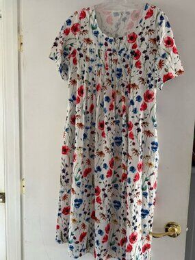 Brand new, never worn. Brightly flowered Polyester nightgown. Marked size M.